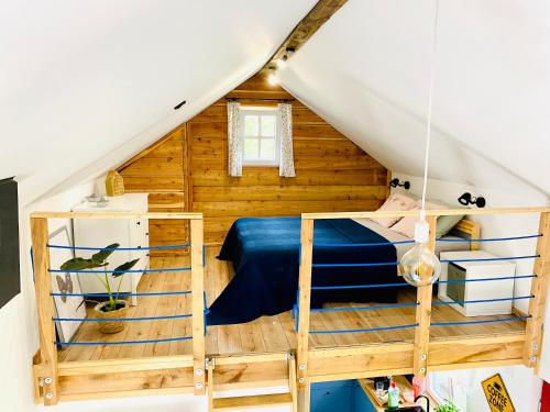 a bedroom with a bunk bed in a attic at Domek TRZY BABY in Dołgie