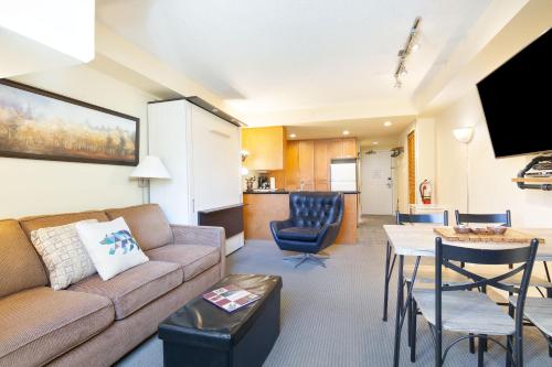 a living room with a couch and a table at Whistler Village Centre by LaTour Hotels and Resorts in Whistler