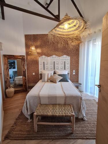 チュイルにあるGite cosy dans une demeure de charme - Romaneの大きなベッドとシャンデリアのある寝室