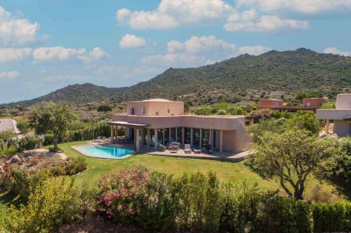 an exterior view of a house with a swimming pool at Is Molas Villas in Pula