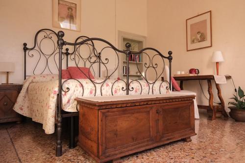 a bedroom with a bed and a wooden dresser at Villa Caotorta in Ponzano Veneto