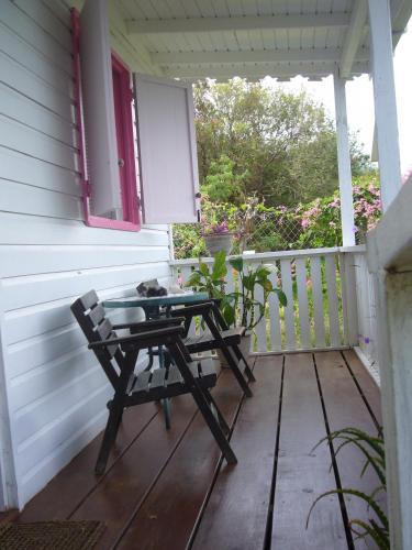 a picnic table on the porch of a house at Green Roof Inn in Carriacou