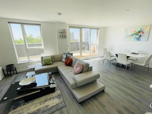 un soggiorno con divano e tavolo di Modern Penthouse flat with Free Indoor Parking a Londra