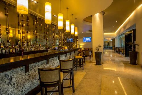 a bar in a restaurant with bar stools at Marival Distinct All-Suites & World Spa - Handwritten Collection in Nuevo Vallarta 