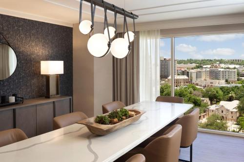 a dining room with a table and chairs and a large window at Hyatt Regency San Antonio Riverwalk in San Antonio