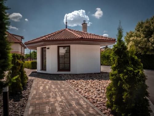 a small white house with a red roof at Hotel Novy Kastiel - Self check-in in Topoľčany