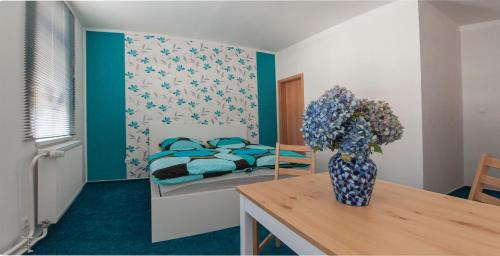 a bedroom with a bed and a vase of flowers on a table at B&B Mediterran Nassau in Nassau