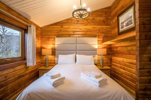 a bedroom with a bed in a log cabin at Muir-lan cabin in Lochinver