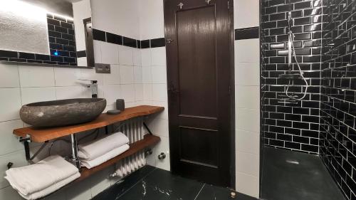 a bathroom with a sink and a shower at La Posada de la Xana in Llanuces