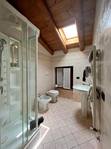 a bathroom with a shower and a toilet and a sink at Casa Cele in Garda