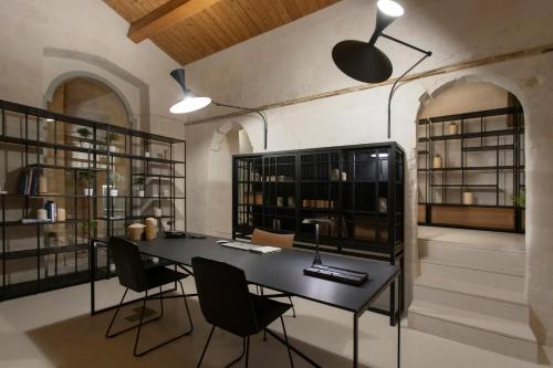 a room with a black table and chairs and shelves at PIANELLE RESORT in Matera