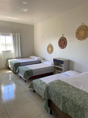 A bed or beds in a room at Pousada Aconchego Santarém