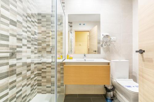 a bathroom with a shower and a sink and a toilet at APARTAMENTOS DELUXE COLLARUBIO en Cercedilla in Cercedilla