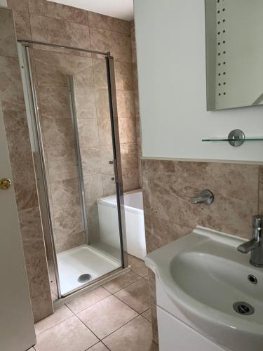 a bathroom with a shower and a sink at Little Withens in Haworth