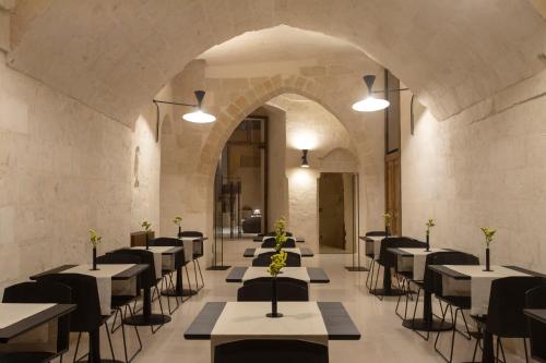 a row of tables and chairs in a room at PIANELLE RESORT in Matera