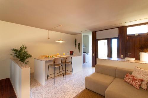 a living room and kitchen with a couch and a table at Enjoy Lisbon Tróia in Troia