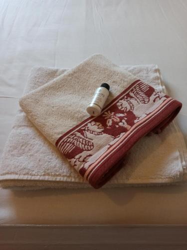 a towel with a bottle on top of it at A&F ioannina apartment in Ioannina