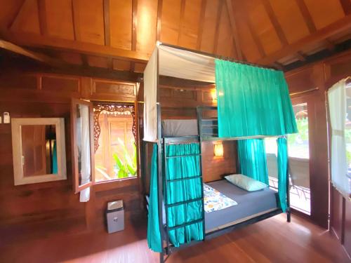 a bedroom with a bunk bed in a room at Ubud Rice Field House in Ubud