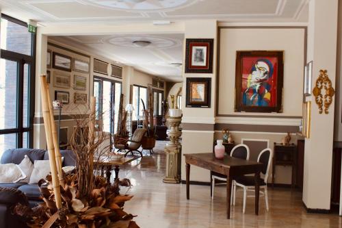 a living room with a table and some chairs at Art Hotel Pandos in Tabiano