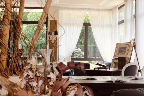 a living room with a table and a large window at Art Hotel Pandos in Tabiano