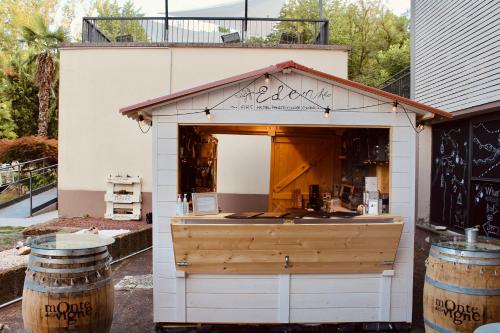 a small store with a barrel in front of it at Art Hotel Pandos in Tabiano