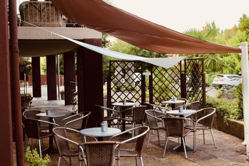 a group of tables and chairs in a patio at Art Hotel Pandos in Tabiano