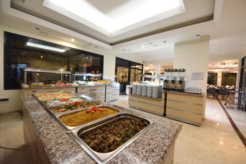 a buffet line with many different types of food at Herakles Thermal Hotel in Pamukkale