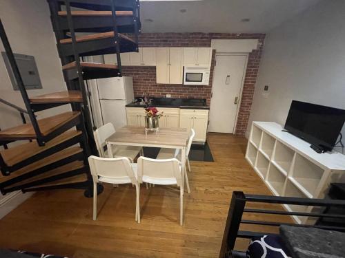 a kitchen with a table and chairs and a staircase at 31 Street Broadway Hotel in New York