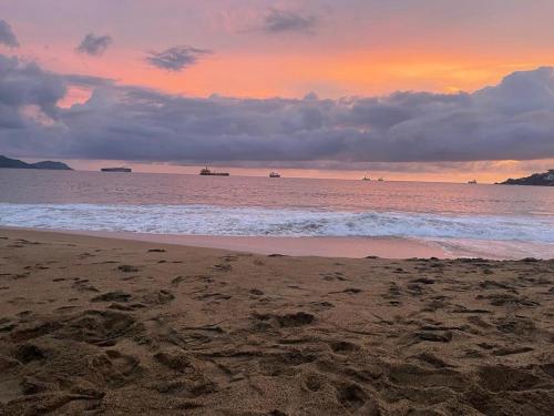 a beach with the ocean and a cloudy sky at Casa Diamante Azul in Manzanillo