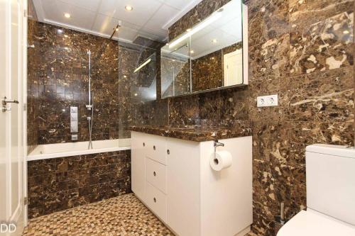 a bathroom with a shower and a toilet and a sink at TAMARINDO in Denia