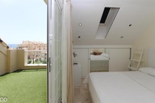 a bedroom with a bed and a large window at TAMARINDO in Denia
