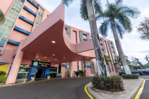 a pink building with a large object sticking out of it at Falls Galli Hotel in Foz do Iguaçu