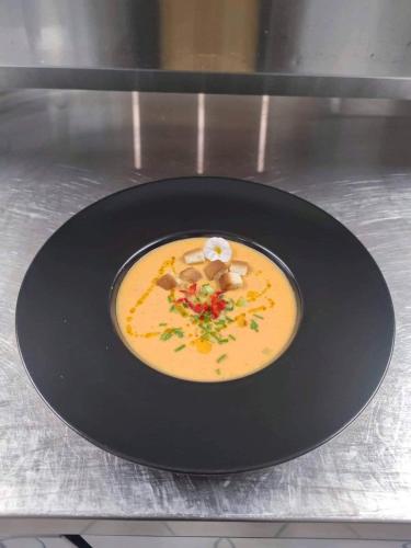 a black plate with a dish of food on a counter at Konstantina Apartments in Kavos