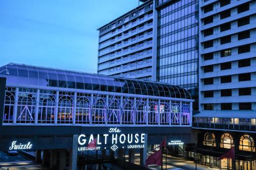 a building with a gothouse in front of two tall buildings at Galt House Hotel, A Trademark Collection Hotel in Louisville