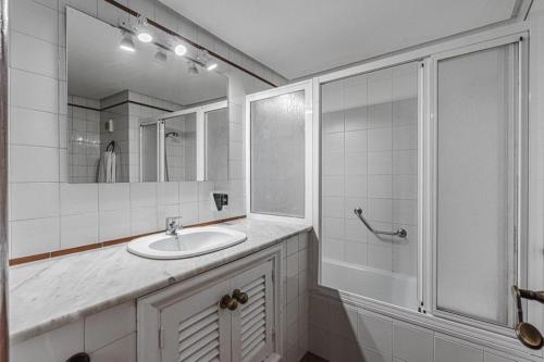 a white bathroom with a sink and a shower at Bleu Torviscas in Adeje