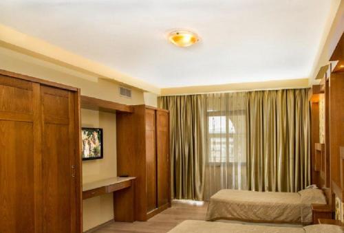 a bedroom with a bed and a window at Grand Hotel Bethlehem in Bethlehem