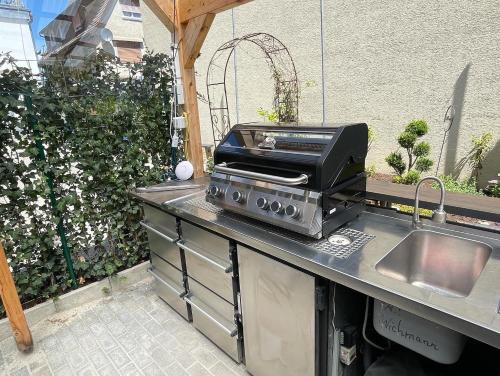 an outdoor kitchen with a toaster and a grill at Sali Homes - GaesteHaus Lamm Obersulm in Obersulm