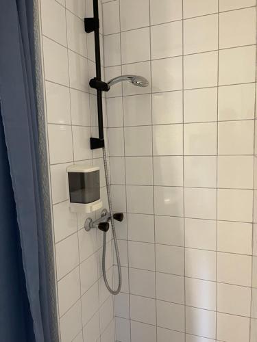 a shower with a shower head in a bathroom at Les Logis de Paray Appartement 202 in Paray-le-Monial