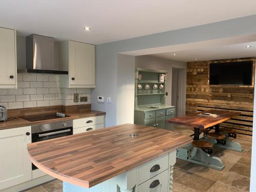 a kitchen with a wooden counter top in it at Sage Gables Mourne Mountains in Annalong