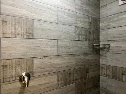 a bathroom with a stone wall at Caribbean Estates 29 Montego Bay in Port Edward