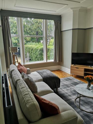 a living room with a couch and a flat screen tv at 34 One in Lytham St Annes
