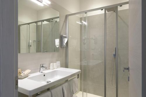 a bathroom with a sink and a shower at Eco Hotel Benacus in Malcesine