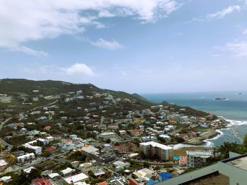 an aerial view of a city and the ocean at Bay View condo in Philipsburg