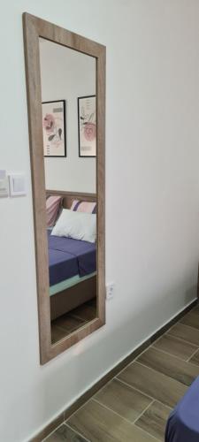 a mirror on a wall in a room with a bed at G&G Suites in Ohrid