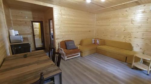 a living room with a couch and a television at Вила ВлаиДа in Sapareva Banya