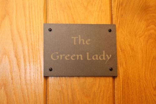 a sign that reads the green lady on a wooden door at Y Fan in Caerphilly
