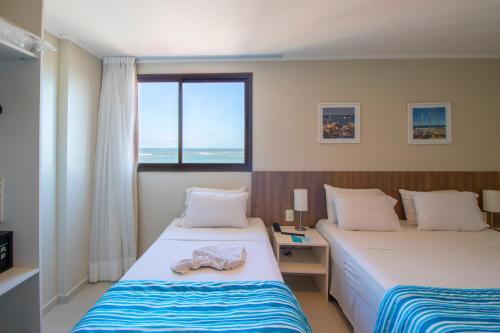 Postel nebo postele na pokoji v ubytování Acqua Inn Maceió Ponta Verde
