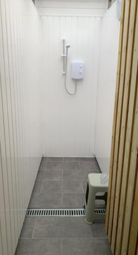 a small bathroom with a toilet and a bench at Bell tent 3 Glyncoch isaf farm in Llwyn-Dafydd