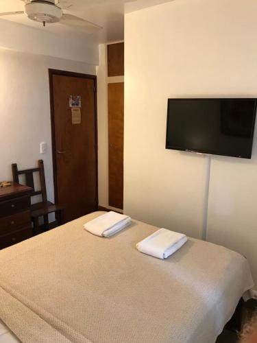 a bedroom with a bed with two towels on it at Hotel Europa in Ostende