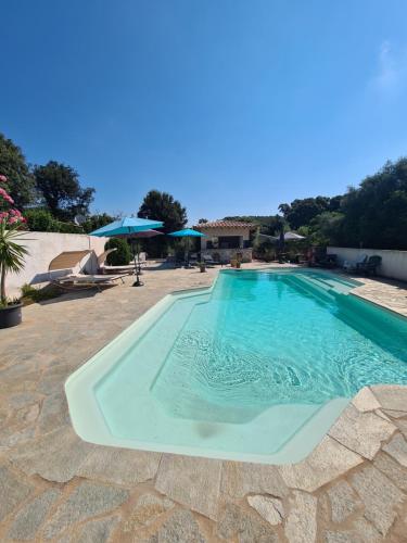 a large swimming pool in the middle of a resort at Perla Di Macchia in Bonifacio